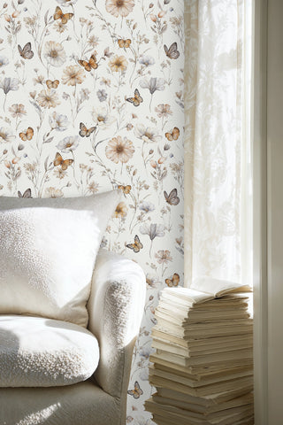 Wildflower butterfly wall mural in soft neutrals, featured in reading nook with textured white armchair
