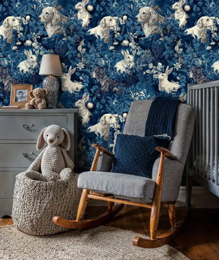 Woodland animals wallpaper with rabbits and dogs in navy and cream, shown in cozy nursery with rocking chair