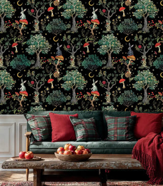 Woodland creature wallpaper with detailed trees and celestial elements in a living room with plaid cushions and rustic table