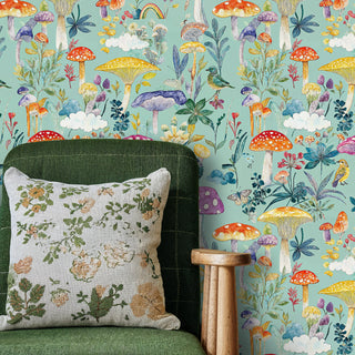 Woodland mushroom wallpaper featuring colorful fungi and wildflowers, shown in living room with green armchair