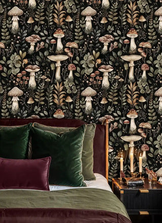 woodland mushroom wallpaper featuring detailed fungi and foliage, shown in cozy bedroom with velvet pillows